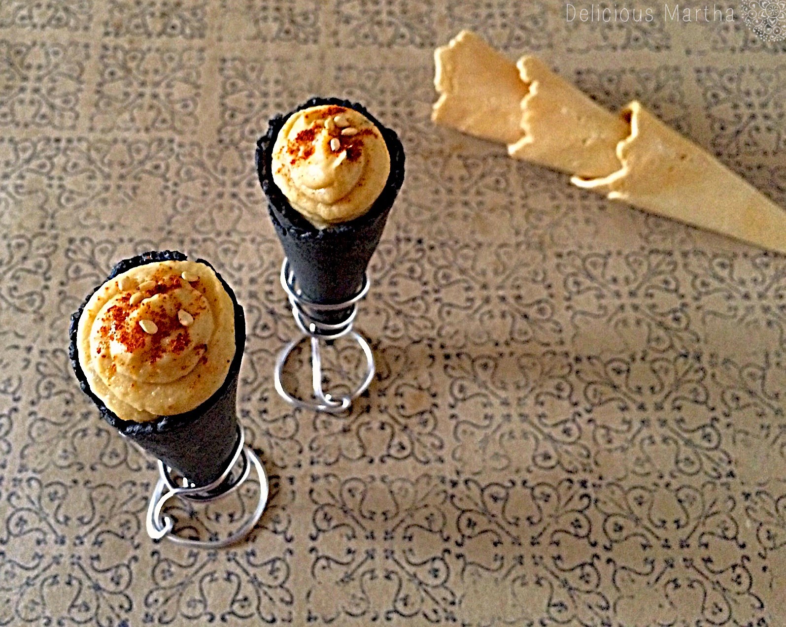 Cucuruchos de carbón vegetal con relleno de hummus con ajo asado
