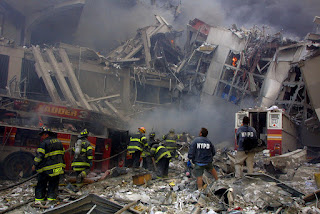 Officers search the rubble of the Twin Towers for survivors