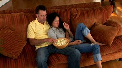 stock-footage-young-couple-on-couch-with-popcorn-watching-tv.jpg