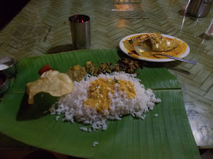 Authentic Kerala fish curry & rice thali served on Banana leaf.