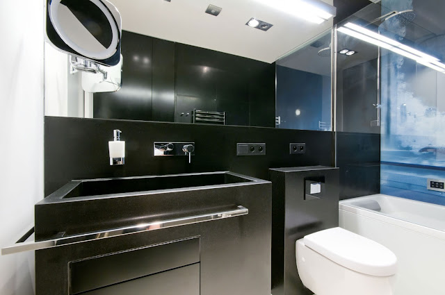 Sink at Home Bathroom with Chrome Towel Bar and Backlit Mirror