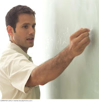 gay teacher writing on chalkboard