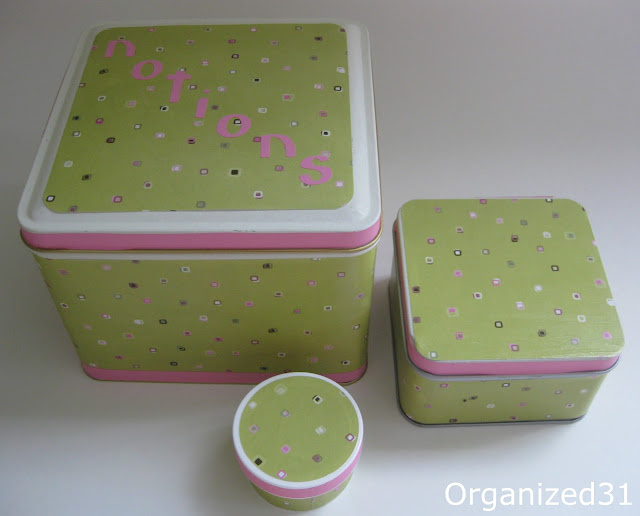 3 containers of different sizes decorated with light green paper with pink, brown and white polka dots and pink stripes on edges of lids