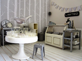 A modern dolls' house miniature homeware shop in grey and white.
