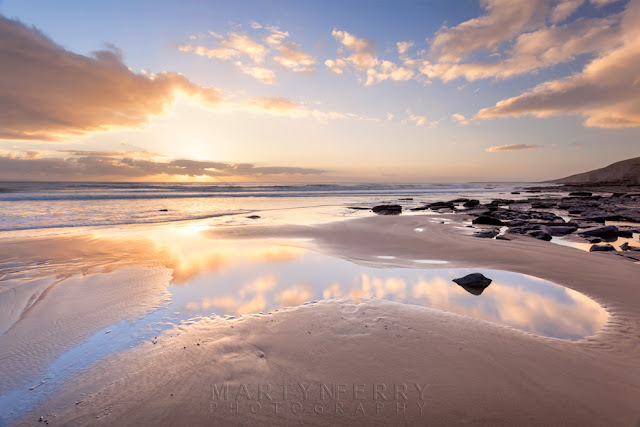 The setting sun over Dunraven Bay in South Wales by Martyn Ferry Photography