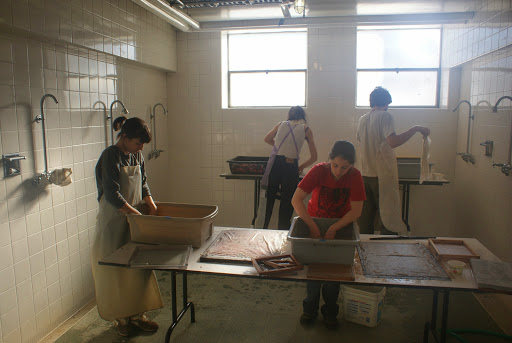 Students with their hands in buckets