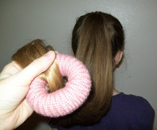 . Bring the last few inches of hair through center of bun maker