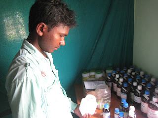 A man in front of a bunch of medical supplies.