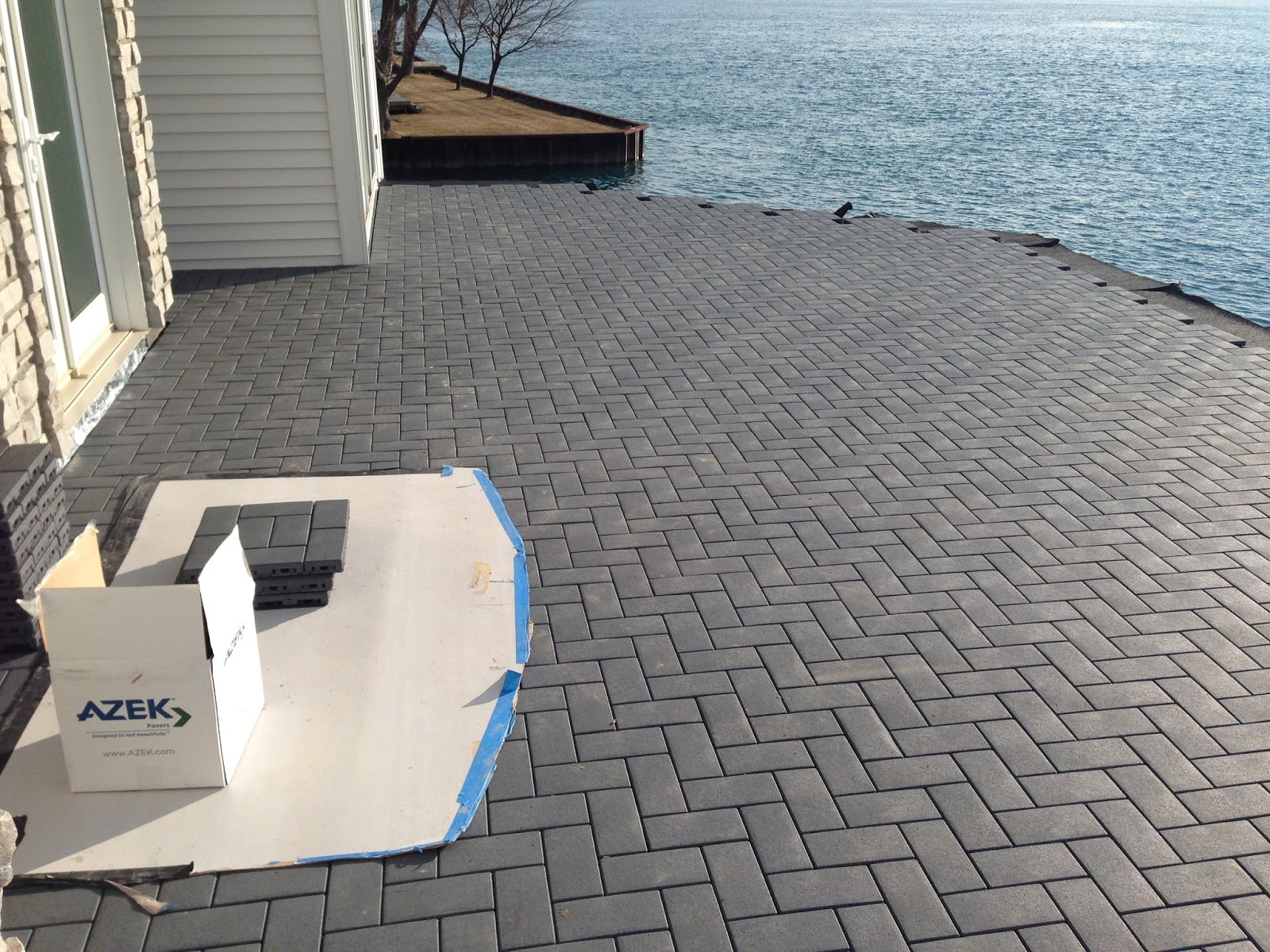 Outdoor Living Low sloped roof decks, composite pavers and cable rail.