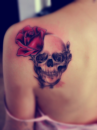 skull and rose tattoo on the back