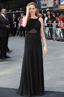 Angelina Jolie posink for cameras in a black dress at red carpet in London