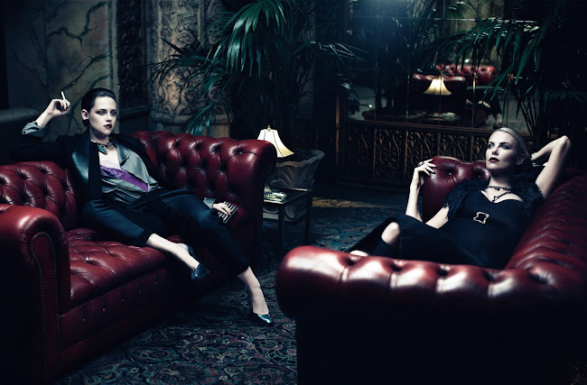 Kristen Stewart and Charlize Theron relaxing on red leather sofas