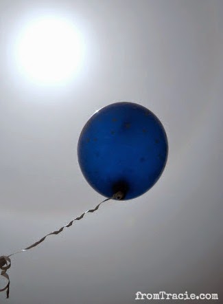 blue balloon floating towards the sun