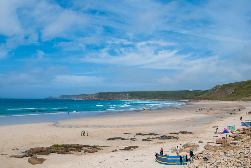 People building tents by the beach in cornwall Sennen cove beach activities, people playing in the sand. west cornwall, england, UK
