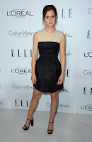 Emma Watson wearing a black dress and matching heels