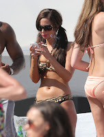 Tulisa Contostavlos in a bikini typing a message on her phone