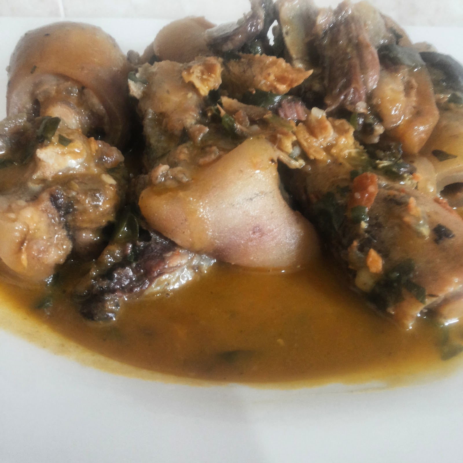 Cooking Nigerian White soup with cow tail and smoked catfish.