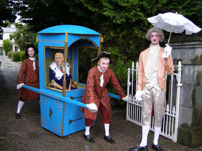Sir Ian Wood carried on a sedan chair to an important event Sir Ian Wood carried on a sedan chair to an important event