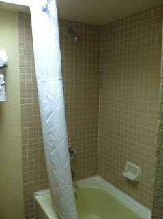 a shower with a white curtain