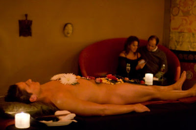 naked male sushi model, in buffet table with foods