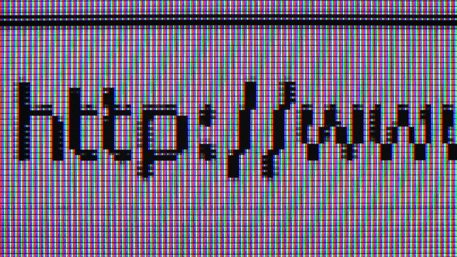 A macro focused close up an lcd monitor with red, green and blue subpixels being displayed.  The screen displays the beginning of a web address in a computer browser.