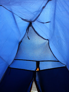 A shot of the roof of a tent from inside. It is all blues.