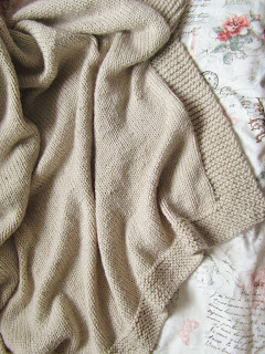 The finished hand knitted blanket perfect for snugglying under when it's cold!