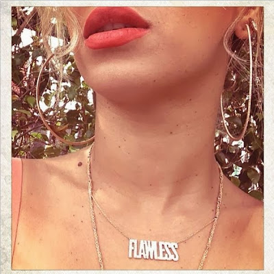 Beyonce wears a "FLAWLESS" name necklace Beyonce wears a "FLAWLESS" name necklace