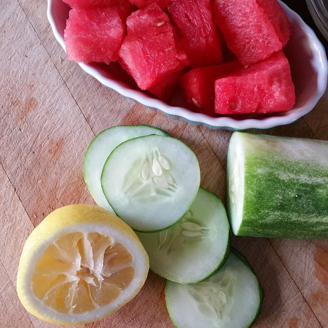 watermelon, cucumber, lemon, wooden cutting board