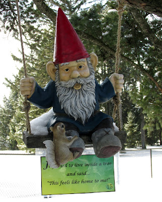 Gnome and squirrel on a swing