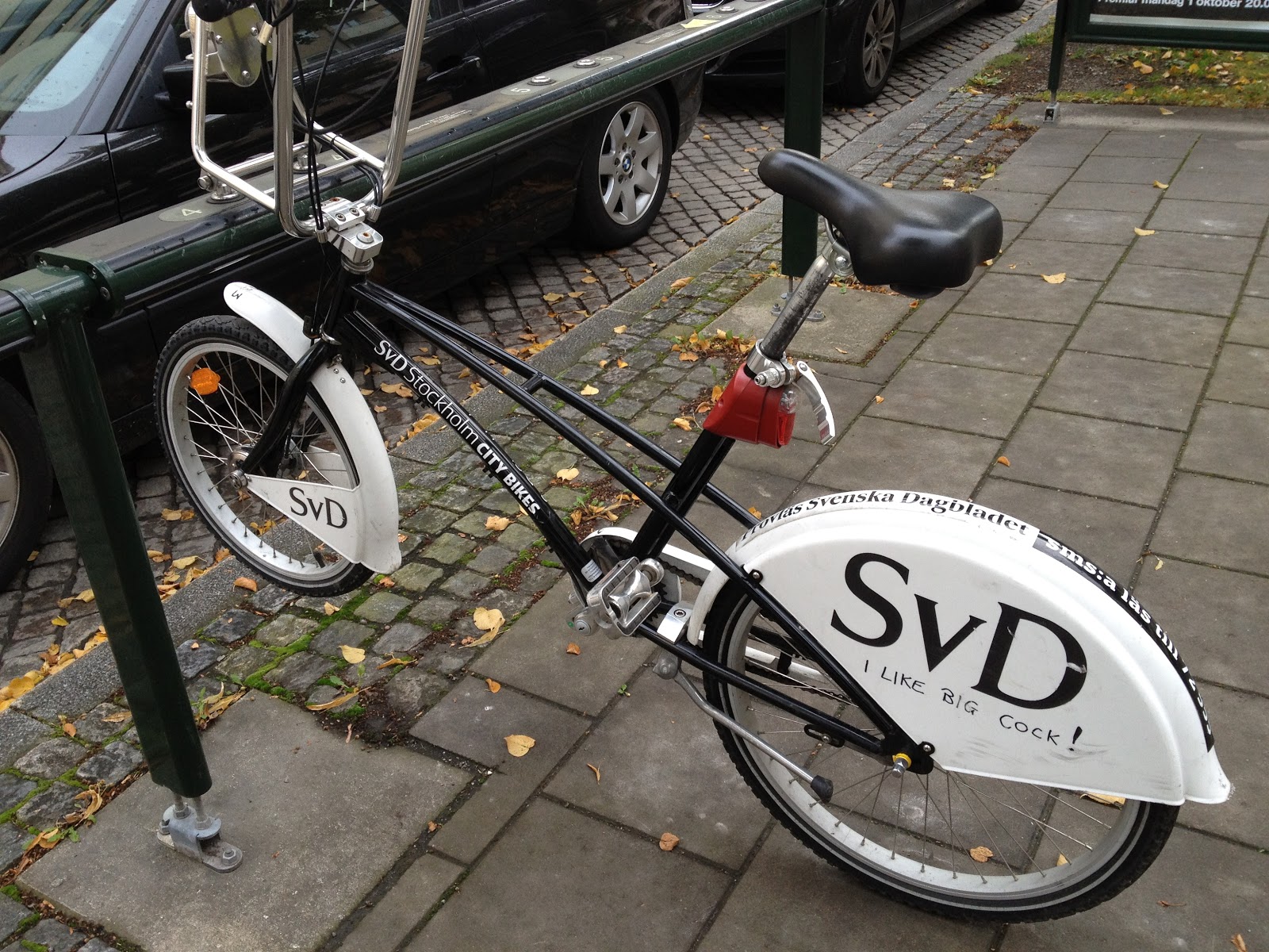 typical bike on a bike stand in Stockholm bike has 3 speed internal hub, coaster brakes, lever brake, kickstand, front and rear fenders, front basket, adjustable seat post, and front and rear lights