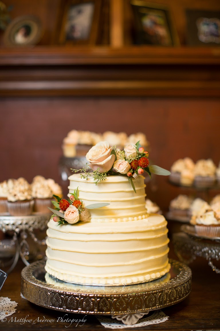 Simple piping on a two tiered wedding cake with flower accents Mokara Floral