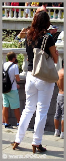 Slender lady in white jeans on the street