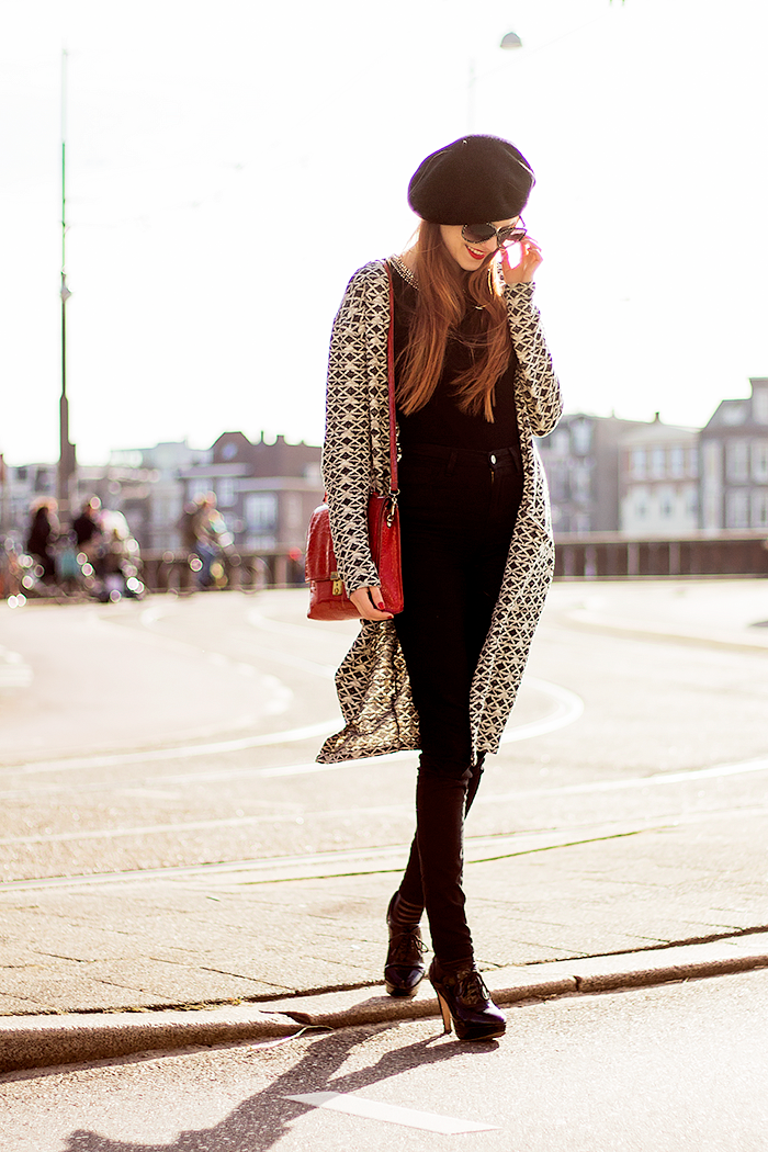 Retro fashion blogger outfit with a long aztec cardigan, beret, high waisted jeans and sheer striped socks