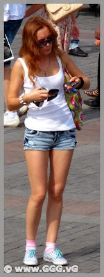 Tanned girl in denim mini shorts on the street