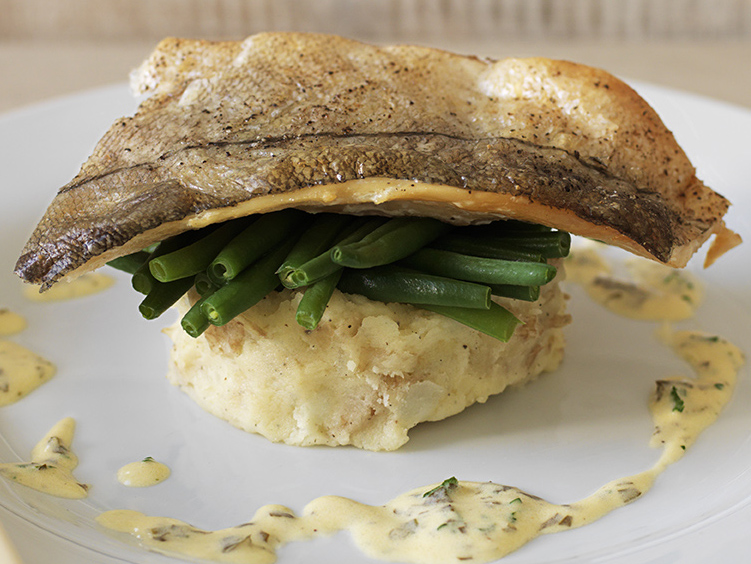 Grilled seabass, crushed new potatoes and buttered asparagus in a