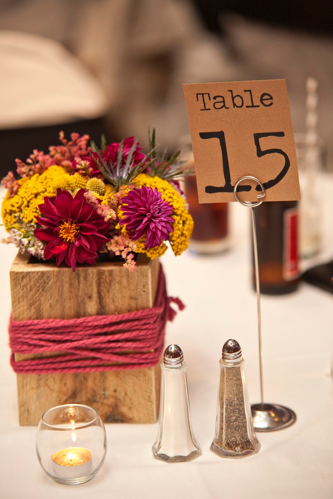 Yarn wrapped wooden box centerpieces with Burgundy Dahlias, Yarrow, Brunia berries, spray roses, thistle, billy balls, and limonium MokaraFloral.com