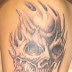 Horrible skull tattoo on upper arm
