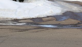 snow melting from south facing roadside photo of snow melting from south facing roadside