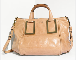 a tan leather handbag with a handle