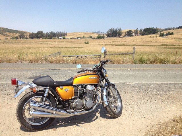 Greggo's finished (for the moment) CB750K6, with K1 side covers and tank in gold and H300 Pipes