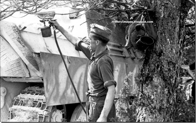 A German soldier gives a Jagdpanther a fresh coat of paint A German soldier gives a Jagdpanther a fresh coat of paint