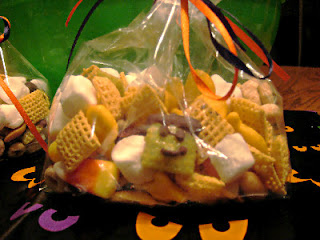 close up of snack mix in a bag with orange ribbon
