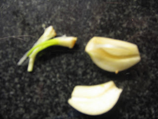 fresh, peeled and halved garlic clove with central tip removed to give odourless garlic