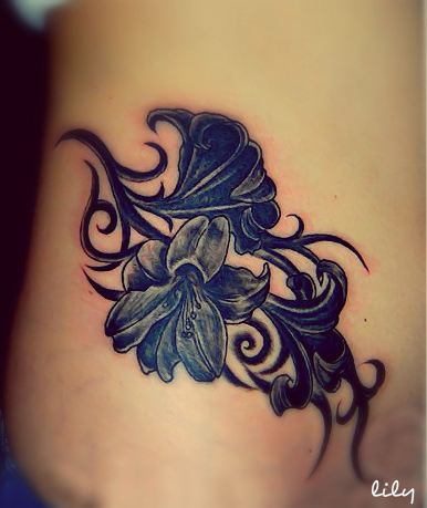 uncommon black lily tattoo on the hip