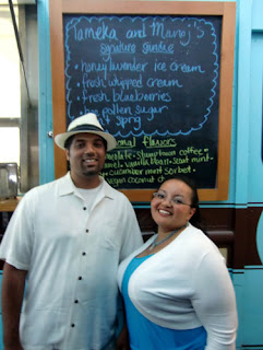 Tameka and Manoj standing in front of the Molly Moon specialty sign Manoj and Tameka in front of the Molly Moon sign with its wedding specialties