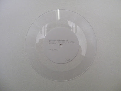 A white disk with writing on it.
