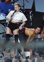 Miley Cyrus touching her back up dancers ass
