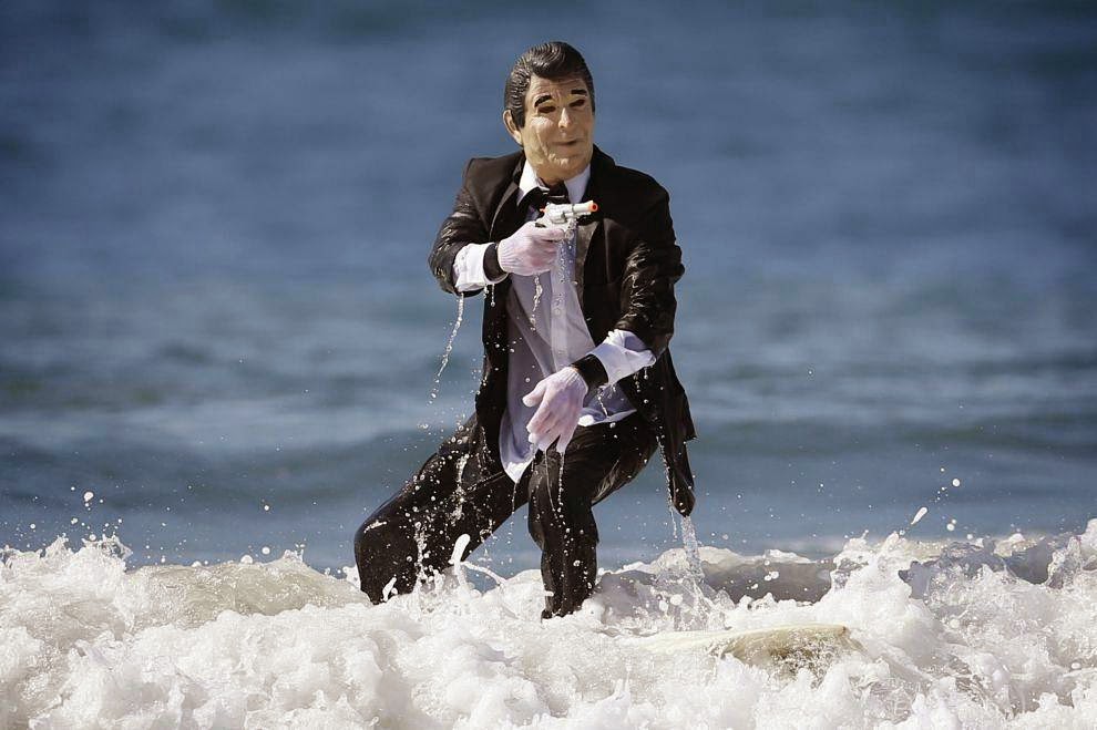 Halloween Surf Contest 2014 JohnPaul Trotter, 31, rides a wave dressed as President Ronald Reagan after competing in the 7th annual ZJ Boarding House Haunted Heats Halloween surf contest. (REUTERS/Lucy Nicholson)
