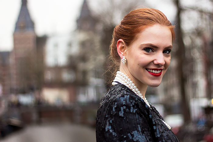 Fashion blogger new years eve outfit with a gold midi dress, sequin jacket, gibson tuck updo and pearls
